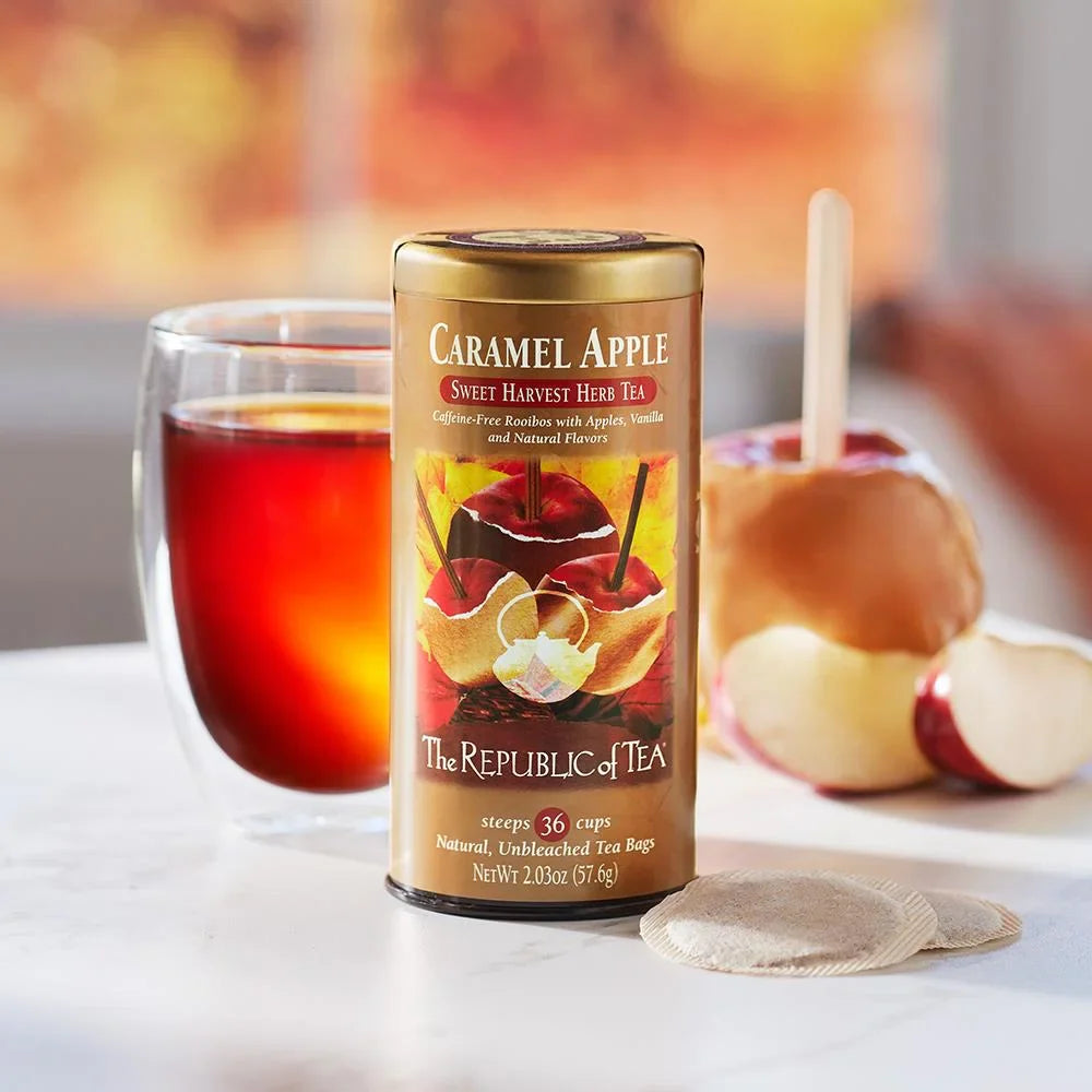 Caramel apple tea tin with apple and glass teacup in the background